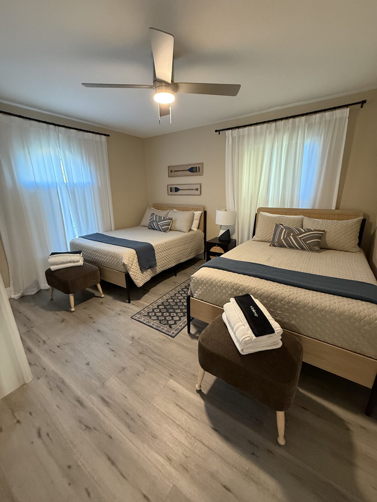 Guest bedroom with two neatly made beds and fresh towels
