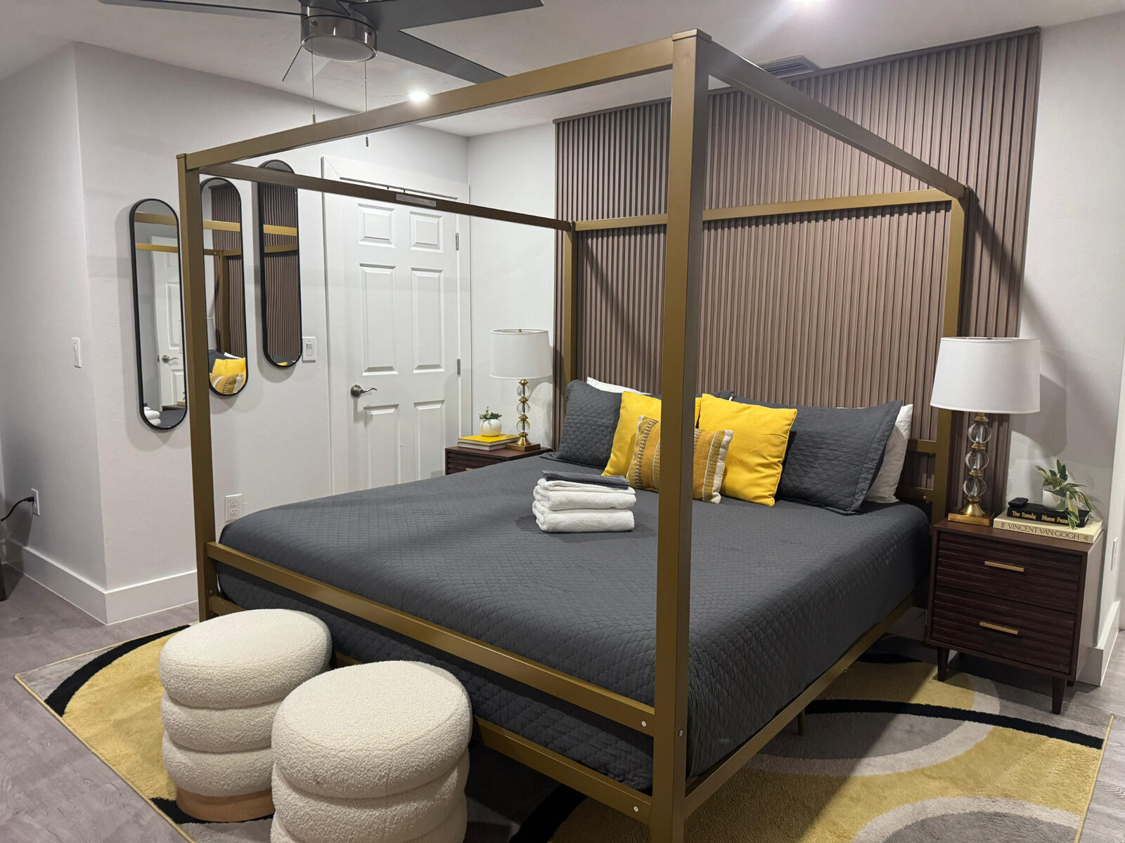 Canopy bed with folded towels in a detailed, tidy bedroom